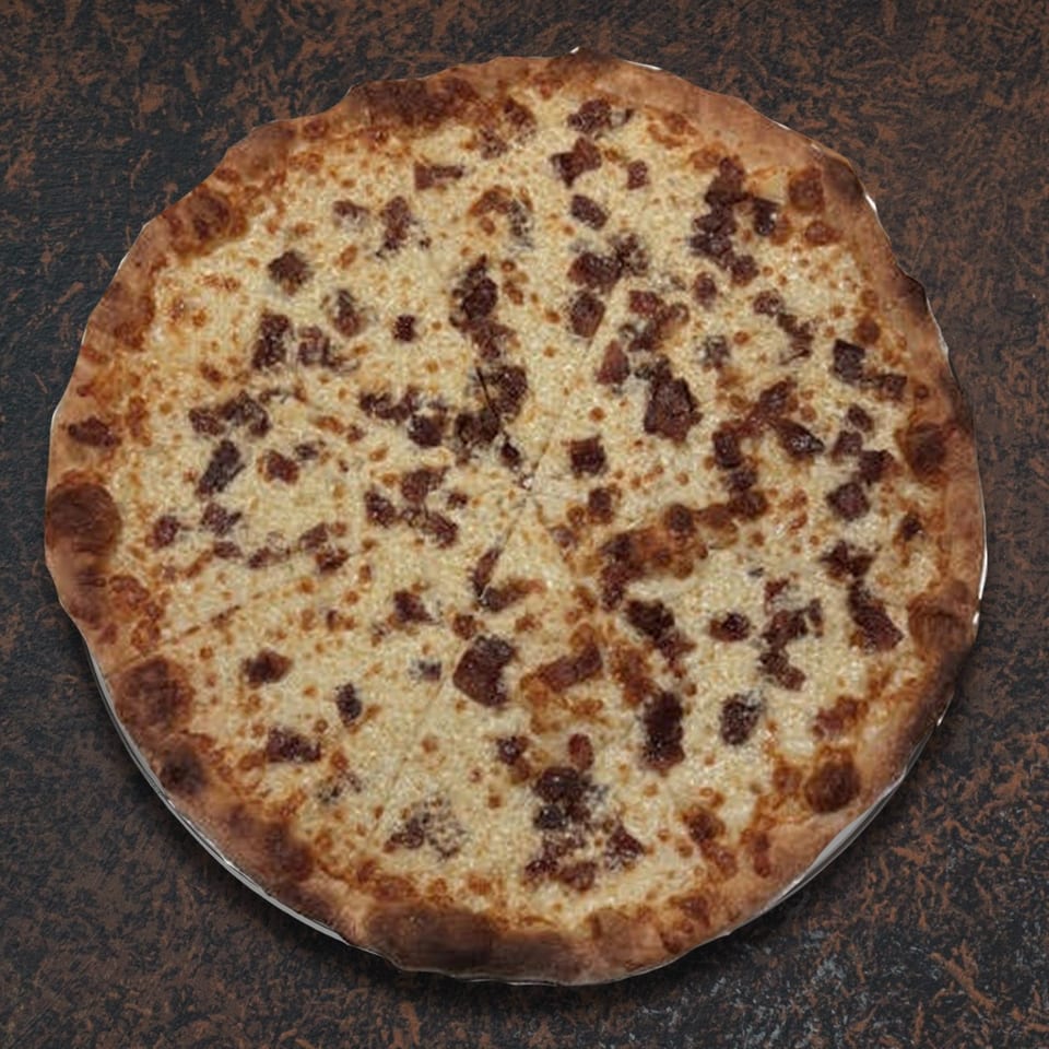 Whole round pizza with white cheese and bacon bits, sliced into eight pieces on a dark surface.