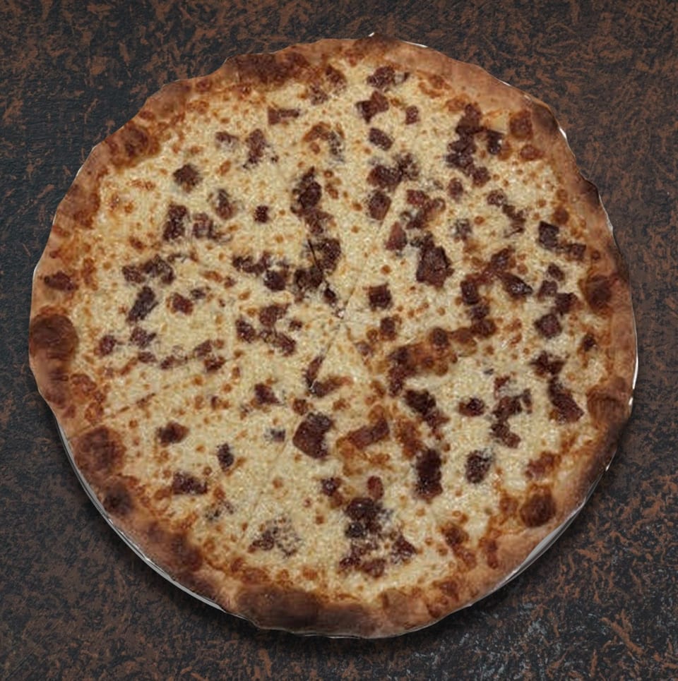 Whole round pizza with white cheese and bacon bits, sliced into eight pieces on a dark surface.