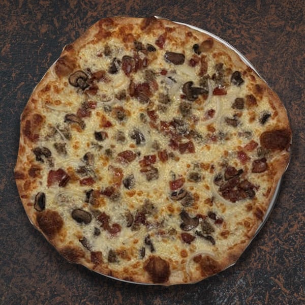 A whole pizza with white sauce, cheese, mushrooms, sausage, bacon, and onions on a dark surface.